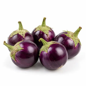 Fresh round ravaya aubergines on a white background
