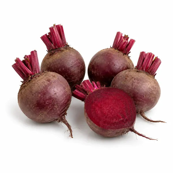 Fresh whole and cut beetroot on a white background