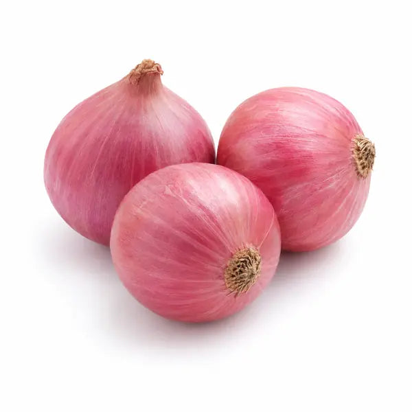 Fresh Indian pink Bombay onions on a white background