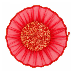 Decorative red thali cover and dry fruit potli on white background