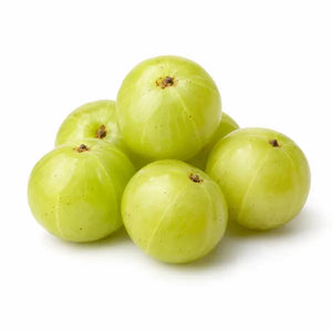 Fresh green Indian gooseberries (amla) on a white background