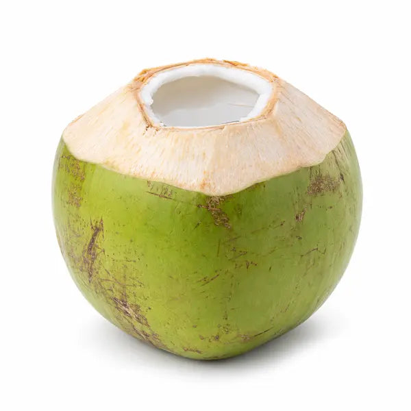 Fresh green coconut with the top cut open on a white background