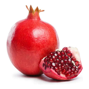 Fresh whole pomegranate with juicy ruby-red arils on a white background