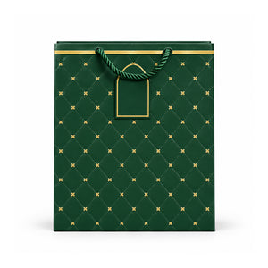 Green and gold floral gift bag with rope handles on white background