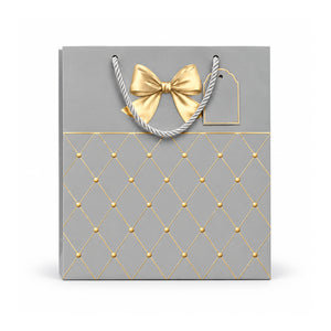 Grey and gold diamond pattern gift bag with bow on white background