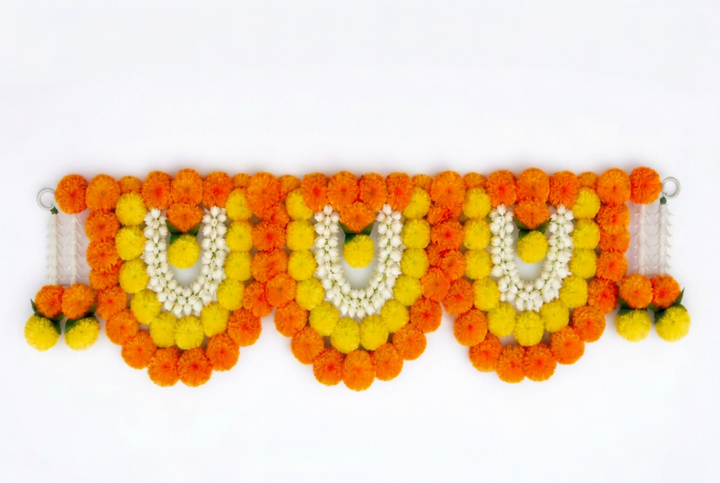 Orange and yellow marigold-style floral toran with three arches and white flower detailing