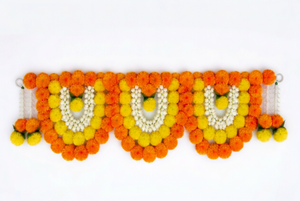 Orange and yellow marigold-style floral toran with three arches and white flower detailing