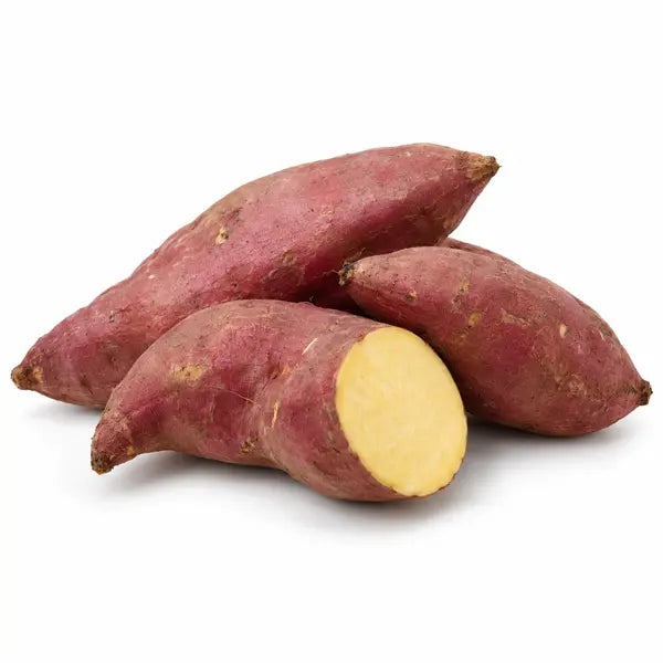 Fresh red sweet potatoes with cut flesh on a white background