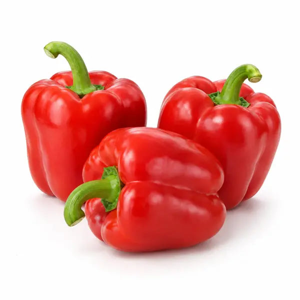 Fresh red bell peppers on a white background