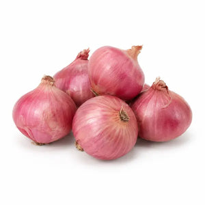 Fresh Indian pink Bombay onions on a white background
