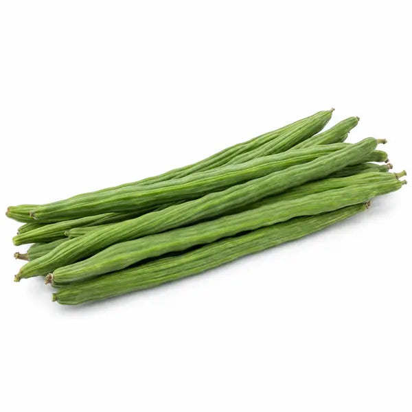 Fresh moringa drumsticks on a white background
