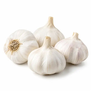 Fresh loose garlic bulbs on a white background