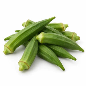 Fresh green okra pods on a white background