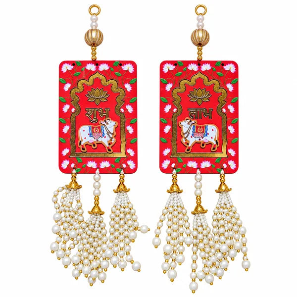 Red Shubh Labh cow hanging pair with lotus floral designs, gold details and white pearl-style bead tassels