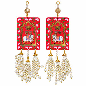 Red Shubh Labh cow hanging pair with lotus floral designs, gold details and white pearl-style bead tassels
